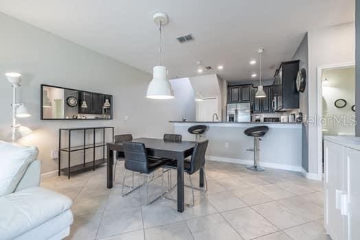 28504 Tranquil Lake Cir, Wesley Chapel, FL 33543 - dining area featuring light tile patterned floors and recessed lighting