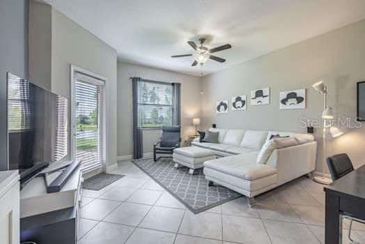 28504 Tranquil Lake Cir, Wesley Chapel, FL 33543 - living room with ceiling fan and light tile patterned floors