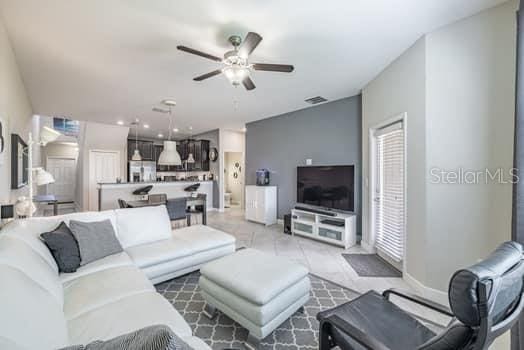 28504 Tranquil Lake Cir, Wesley Chapel, FL 33543 - living room with a ceiling fan