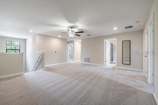 28504 Tranquil Lake Cir, Wesley Chapel, FL 33543 - carpeted spare room featuring recessed lighting and ceiling fan