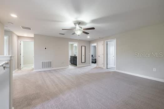 28504 Tranquil Lake Cir, Wesley Chapel, FL 33543 - unfurnished living room with ceiling fan, carpet, and recessed lighting
