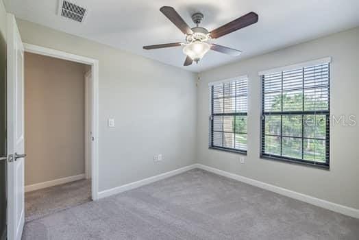 28504 Tranquil Lake Cir, Wesley Chapel, FL 33543 - empty room with carpet flooring and a ceiling fan