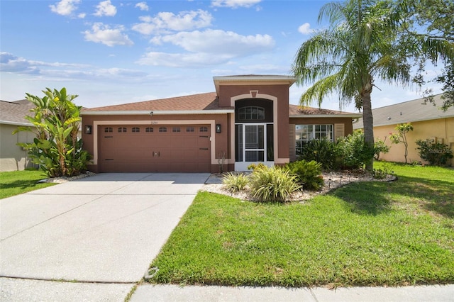 31244 Baclan Dr, Wesley Chapel, FL 33545 - ranch-style house featuring an attached garage, driveway, a front yard, and stucco siding