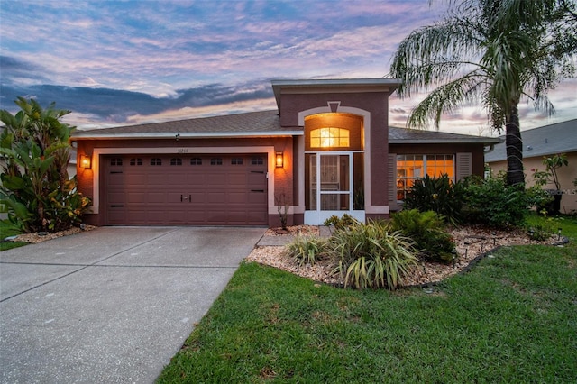31244 Baclan Dr, Wesley Chapel, FL 33545 - ranch-style home with an attached garage, concrete driveway, and stucco siding