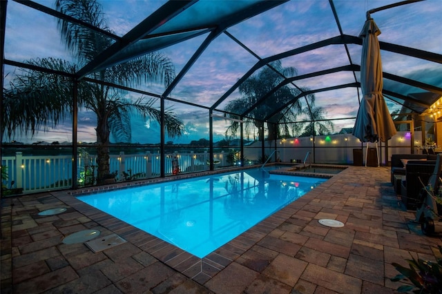 31244 Baclan Dr, Wesley Chapel, FL 33545 - pool at dusk featuring an outdoor pool, a patio, and glass enclosure