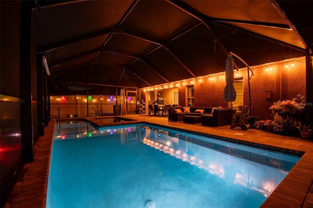 31244 Baclan Dr, Wesley Chapel, FL 33545 - pool at night with an outdoor pool, an outdoor living space, and a patio