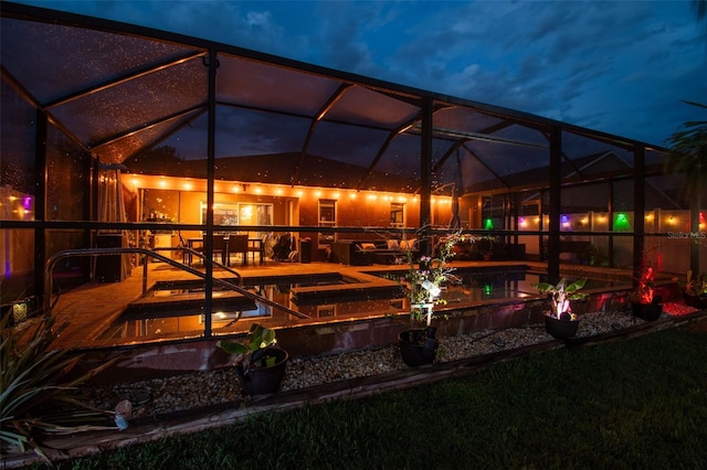 31244 Baclan Dr, Wesley Chapel, FL 33545 - back of house at twilight featuring a lanai