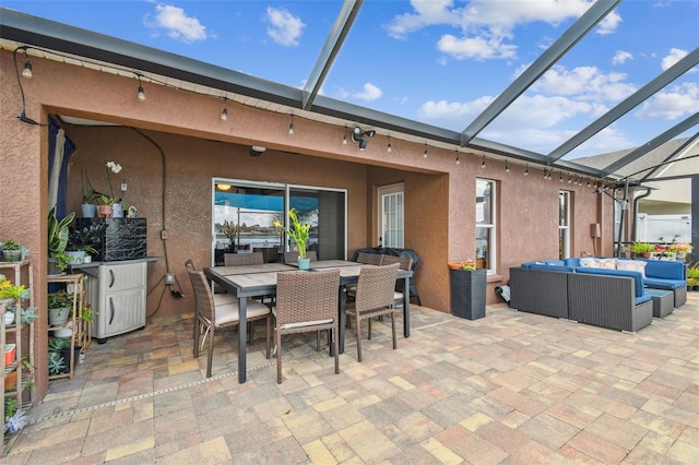 31244 Baclan Dr, Wesley Chapel, FL 33545 - view of patio featuring outdoor lounge area, outdoor dining space, and glass enclosure