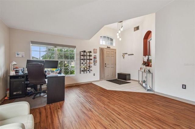 31244 Baclan Dr, Wesley Chapel, FL 33545 - home office with vaulted ceiling, wood finished floors, and arched walkways