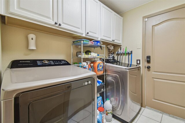 31244 Baclan Dr, Wesley Chapel, FL 33545 - laundry area with independent washer and dryer, cabinet space, and light tile patterned floors