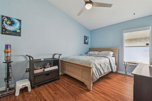 31244 Baclan Dr, Wesley Chapel, FL 33545 - bedroom with lofted ceiling, wood finished floors, and a ceiling fan