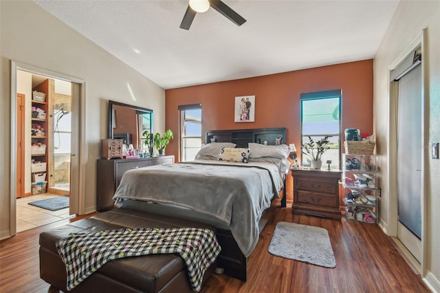 31244 Baclan Dr, Wesley Chapel, FL 33545 - bedroom with vaulted ceiling, wood finished floors, ceiling fan, and connected bathroom