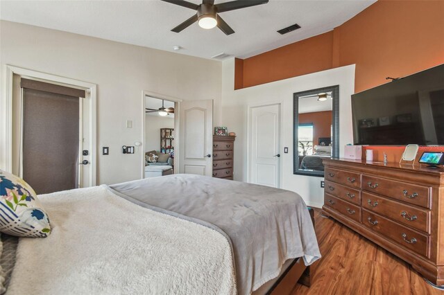 31244 Baclan Dr, Wesley Chapel, FL 33545 - bedroom with wood finished floors, ceiling fan, and connected bathroom