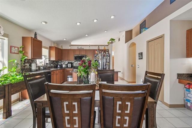 31244 Baclan Dr, Wesley Chapel, FL 33545 - dining space featuring light tile patterned floors, arched walkways, and recessed lighting