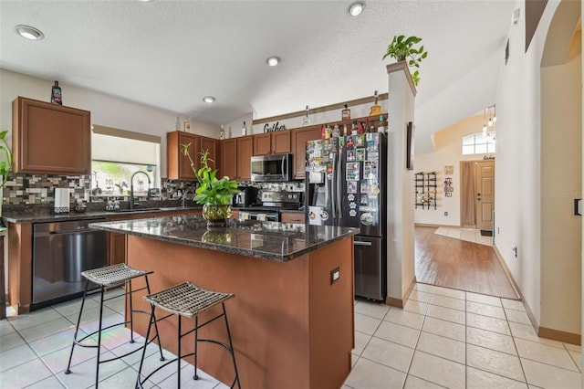 31244 Baclan Dr, Wesley Chapel, FL 33545 - kitchen featuring appliances with stainless steel finishes, backsplash, a center island, a breakfast bar, and recessed lighting