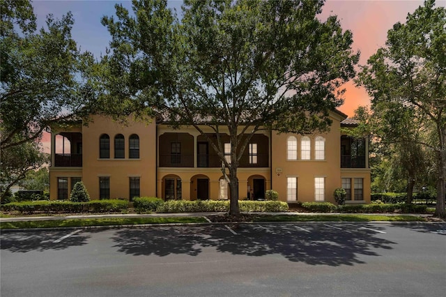 504 Mirasol Cir Unit 102, Kissimmee, FL 34747 - property at dusk featuring uncovered parking