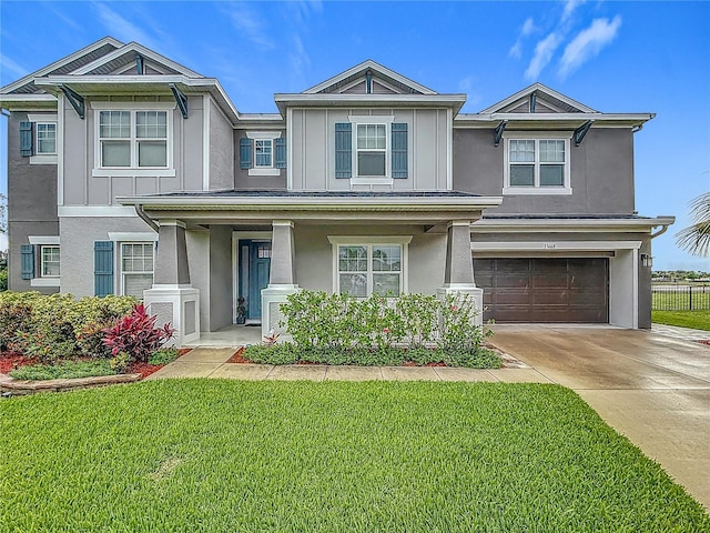 33668 Willow Point Ct, Wesley Chapel, FL 33545 - view of front of house featuring stucco siding, an attached garage, concrete driveway, and covered porch