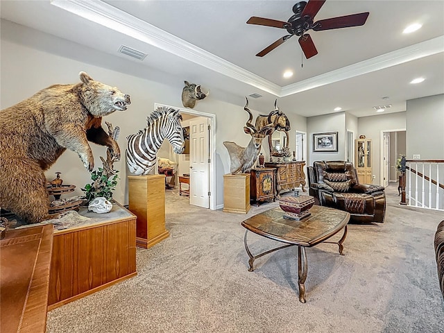 33668 Willow Point Ct, Wesley Chapel, FL 33545 - living area with crown molding, light colored carpet, a tray ceiling, ceiling fan, and recessed lighting