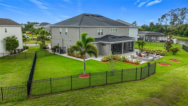 33668 Willow Point Ct, Wesley Chapel, FL 33545 - back of house with a sunroom, a fenced backyard, stucco siding, and a water view