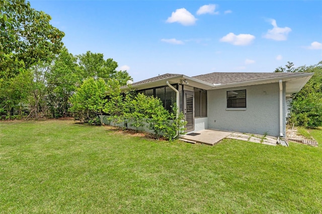 10237 Carrin Rd, Spring Hill, FL 34608 - back of house featuring a sunroom, a yard, and stucco siding