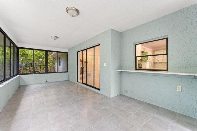 10237 Carrin Rd, Spring Hill, FL 34608 - unfurnished sunroom with a textured wall