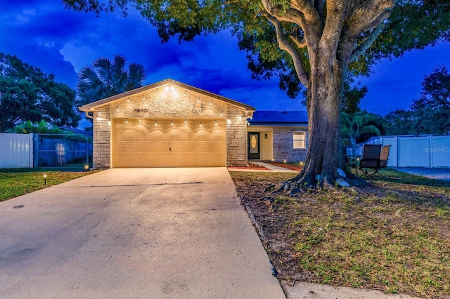 1910 Montego Ct, Oldsmar, FL 34677 - ranch-style house featuring stone siding, a garage, and driveway