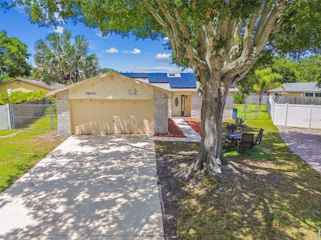 1910 Montego Ct, Oldsmar, FL 34677 - view of front of house featuring driveway, roof mounted solar panels, and an attached garage