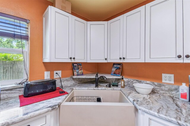 1910 Montego Ct, Oldsmar, FL 34677 - kitchen featuring white cabinetry and light stone countertops