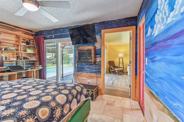 1910 Montego Ct, Oldsmar, FL 34677 - bedroom featuring a textured ceiling, access to exterior, wallpapered walls, stone tile flooring, and a ceiling fan