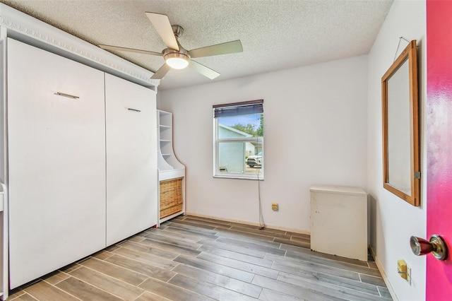 1910 Montego Ct, Oldsmar, FL 34677 - unfurnished bedroom with wood finished floors, ceiling fan, and a textured ceiling