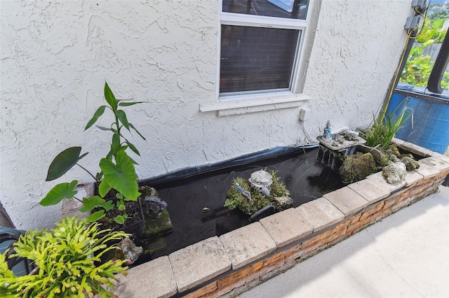 1910 Montego Ct, Oldsmar, FL 34677 - exterior view of stucco siding and a central AC unit