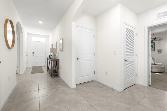 9098 Forge Breeze Loop, Wesley Chapel, FL 33545 - hallway featuring arched walkways, light tile patterned floors, and recessed lighting