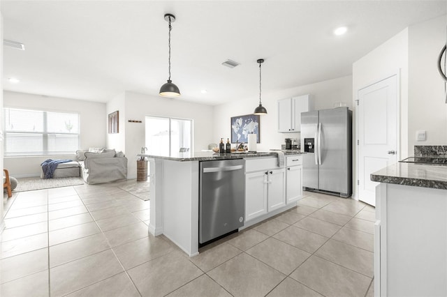 9098 Forge Breeze Loop, Wesley Chapel, FL 33545 - kitchen featuring stainless steel appliances, light tile patterned floors, white cabinetry, dark stone countertops, and recessed lighting