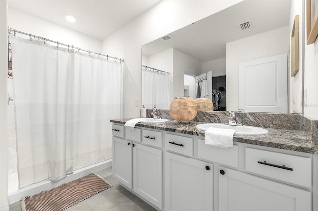 9098 Forge Breeze Loop, Wesley Chapel, FL 33545 - bathroom with double vanity and tile patterned floors