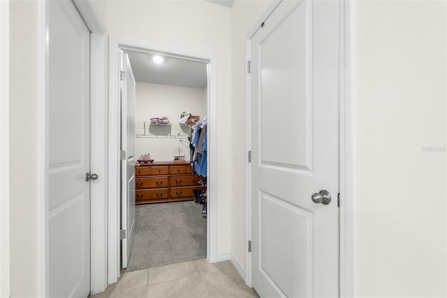 9098 Forge Breeze Loop, Wesley Chapel, FL 33545 - hallway featuring light colored carpet and light tile patterned floors