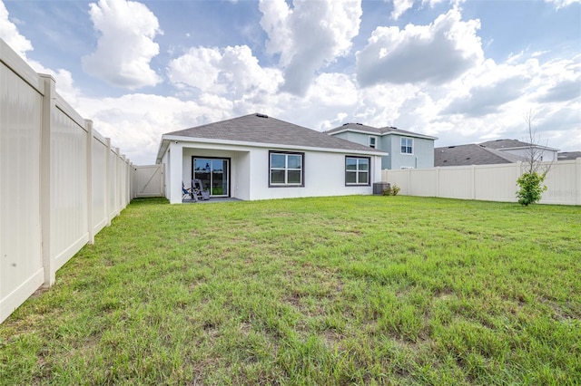9098 Forge Breeze Loop, Wesley Chapel, FL 33545 - rear view of house with a fenced backyard, stucco siding, and roof with shingles