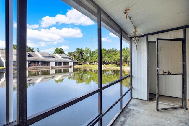 500 New York Ave Unit 22, Dunedin, FL 34698 - unfurnished sunroom featuring a water view