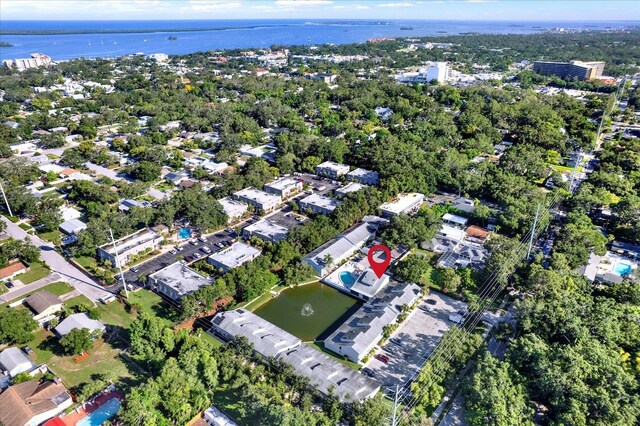 500 New York Ave Unit 22, Dunedin, FL 34698 - aerial view of property and surrounding area with a large body of water and a tree filled landscape