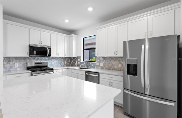 6133 Wire Grass Ct, Nokomis, FL 34275 - kitchen with appliances with stainless steel finishes, tasteful backsplash, white cabinets, light stone counters, and recessed lighting