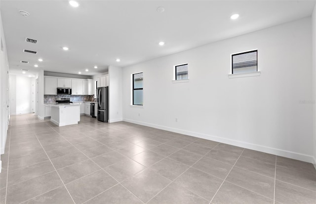 6133 Wire Grass Ct, Nokomis, FL 34275 - unfurnished living room featuring light tile patterned floors and recessed lighting
