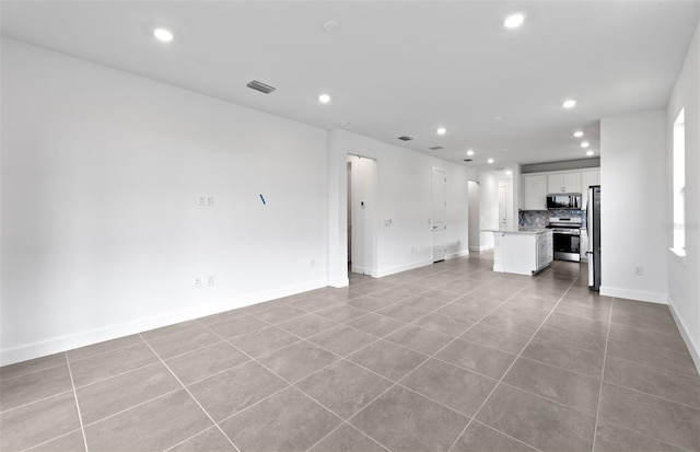 6133 Wire Grass Ct, Nokomis, FL 34275 - unfurnished living room featuring recessed lighting and tile patterned flooring
