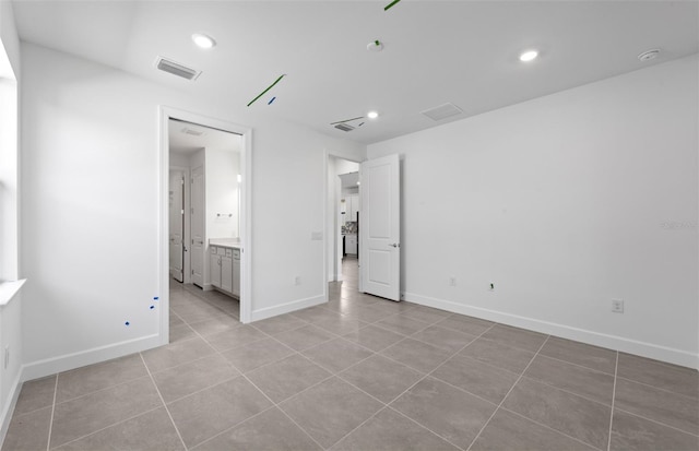 6133 Wire Grass Ct, Nokomis, FL 34275 - unfurnished bedroom featuring light tile patterned flooring, recessed lighting, and connected bathroom