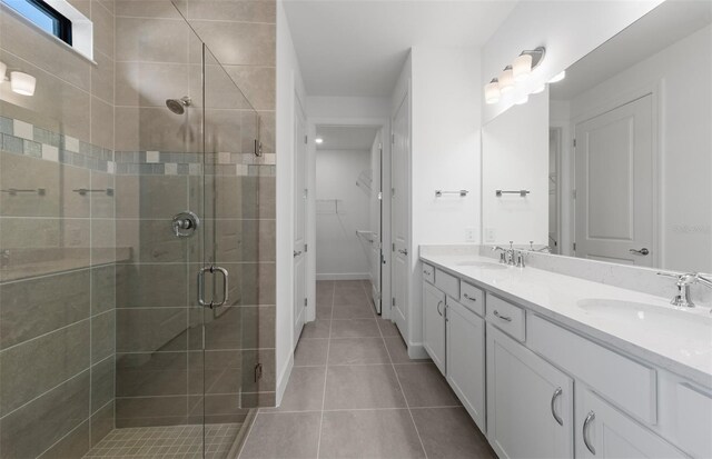 6133 Wire Grass Ct, Nokomis, FL 34275 - bathroom featuring double vanity, a shower stall, and tile patterned floors