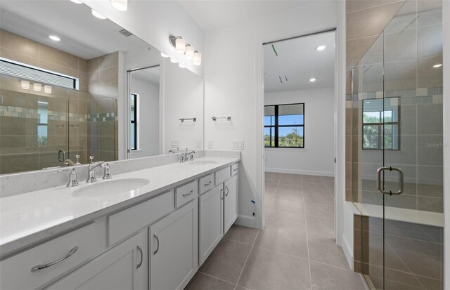 6133 Wire Grass Ct, Nokomis, FL 34275 - bathroom featuring double vanity, tile patterned flooring, a stall shower, and recessed lighting