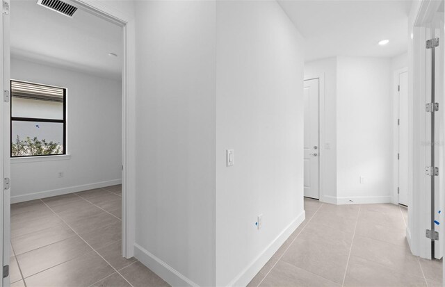 6133 Wire Grass Ct, Nokomis, FL 34275 - hallway with light tile patterned floors and recessed lighting