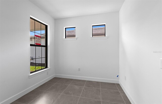 6133 Wire Grass Ct, Nokomis, FL 34275 - unfurnished room featuring dark tile patterned flooring and baseboards