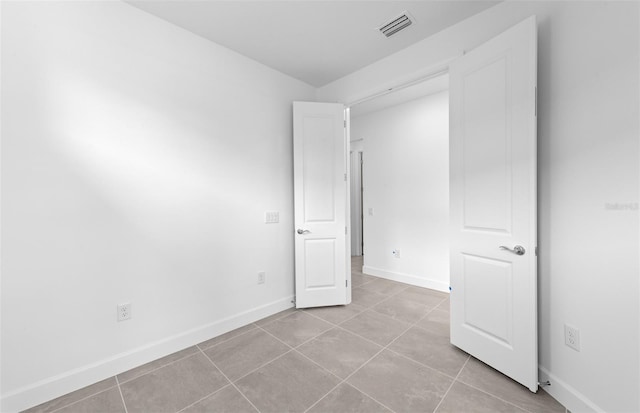 6133 Wire Grass Ct, Nokomis, FL 34275 - spare room with tile patterned flooring and baseboards