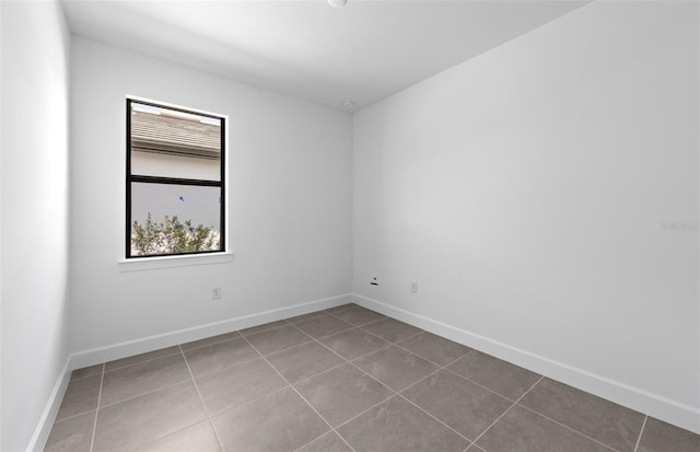 6133 Wire Grass Ct, Nokomis, FL 34275 - tiled empty room with baseboards