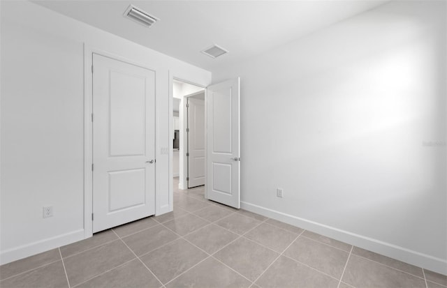 6133 Wire Grass Ct, Nokomis, FL 34275 - spare room featuring light tile patterned flooring and baseboards