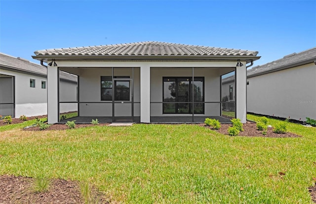 6133 Wire Grass Ct, Nokomis, FL 34275 - rear view of property featuring a tile roof, a yard, and stucco siding